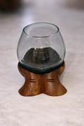 Slump vase on wooden carved hands